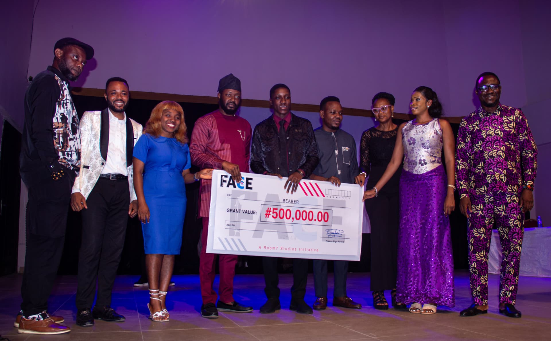 FACE 2025 grant presentation with a 500,000 Naira cheque on stage in Uyo